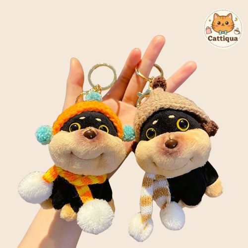 Close-up of two bee dog plush keychains held in hand, showing soft texture and cute details, aesthetic kawaii plush pendant for bag charm